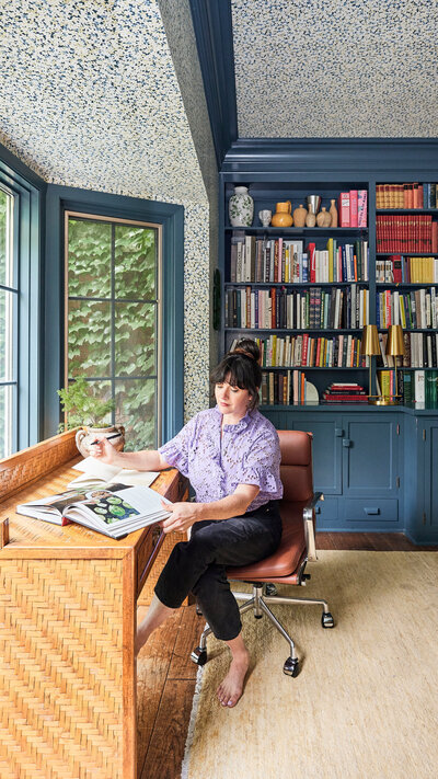 Woman  sitting in a windowsill with her feet kicked up